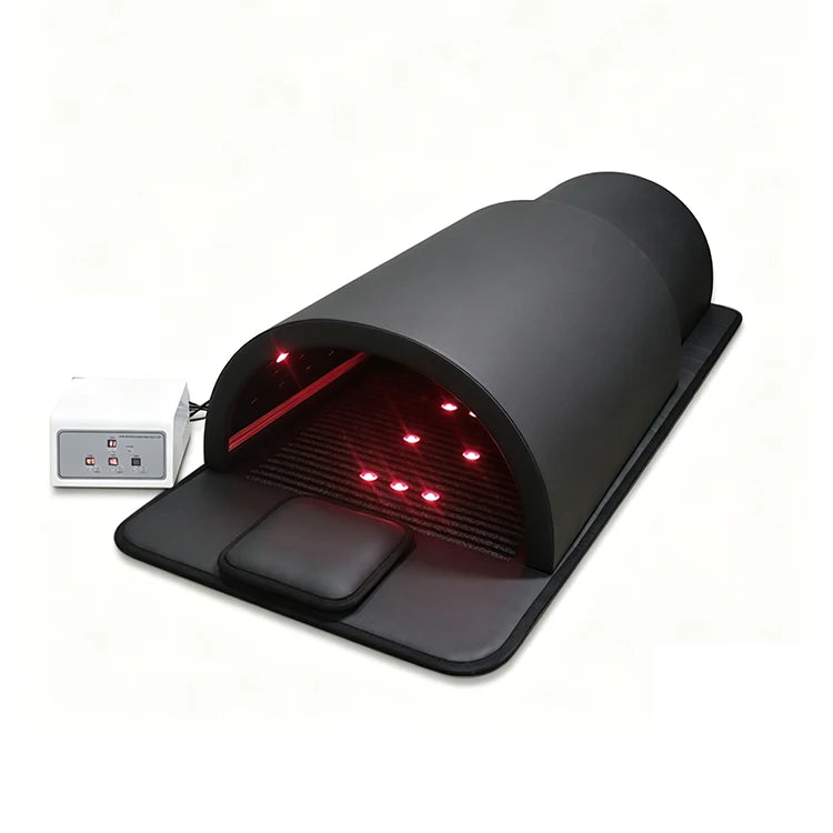 Angled view of the black far-infrared sauna dome with red interior lights