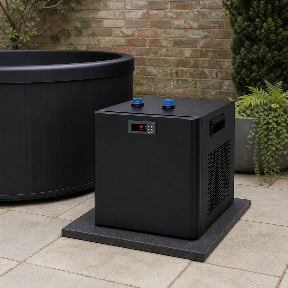 Elevn Chill compact water chiller beside a cold plunge on a British garden patio